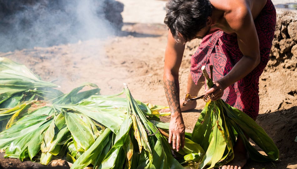 man preparing a traditional Imu cooking fire