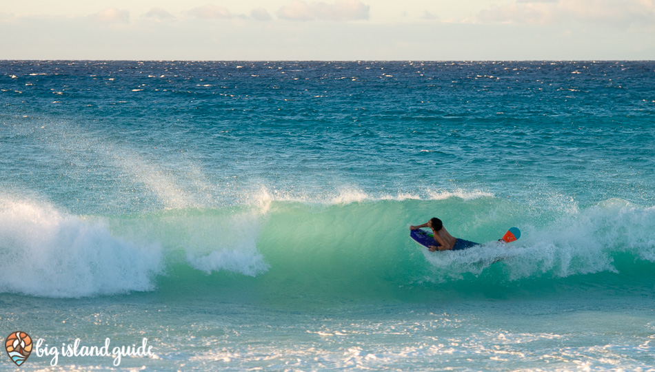 riding waves at Maniniowali Beach at Kua Bay