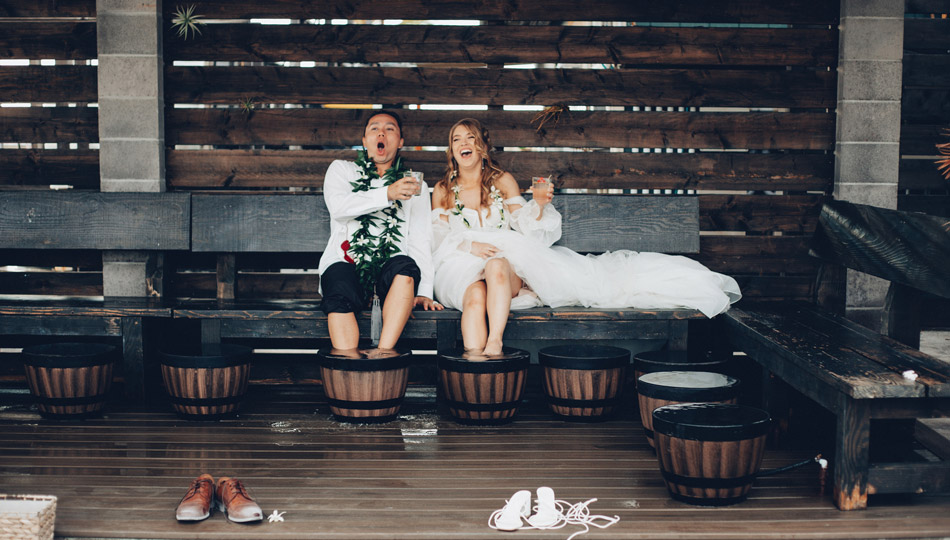 kona salt farm foot soaking area with a couple in their wedding attire soaking their feet